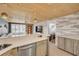 Kitchen counter extends into living area featuring sleek countertops and open floorplan at 308 Normandy Ave, New Smyrna Beach, FL 32169