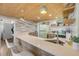Charming kitchen featuring a retro refrigerator, stylish backsplash, and a breakfast bar with modern seating at 308 Normandy Ave, New Smyrna Beach, FL 32169