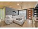 Inviting living room with cozy seating, wood ceilings, and natural light, creating a comfortable gathering space at 308 Normandy Ave, New Smyrna Beach, FL 32169