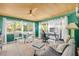 Cozy living space features tile flooring, a ceiling fan, and natural lighting at 308 Normandy Ave, New Smyrna Beach, FL 32169
