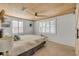 Serene main bedroom with a ceiling fan, neutral decor, and plantation shutters for privacy and light control at 308 Normandy Ave, New Smyrna Beach, FL 32169
