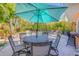 Patio with dining area and lush views of the swimming pool at 308 Normandy Ave, New Smyrna Beach, FL 32169