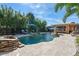 A serene backyard featuring a swimming pool, lounge chairs, and lush greenery; perfect for relaxation and outdoor enjoyment at 308 Normandy Ave, New Smyrna Beach, FL 32169