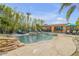 Inviting pool and spa area with tiki bar, lush landscaping, and lounge seating at 308 Normandy Ave, New Smyrna Beach, FL 32169