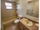 Cozy bathroom with neutral tile, single sink vanity, tub shower combination, and modern fixtures at 309 & 311 Sea Hawk Ct, Edgewater, FL 32141