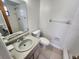 Functional bathroom with single sink vanity, toilet, and shower/bath combination with neutral finishes at 309 & 311 Sea Hawk Ct, Edgewater, FL 32141