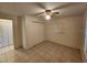 Comfortable bedroom featuring tiled floors, ceiling fan, and ample closet space at 309 & 311 Sea Hawk Ct, Edgewater, FL 32141