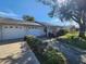 Well-maintained single-story home with an attached garage and mature landscaping at 309 & 311 Sea Hawk Ct, Edgewater, FL 32141