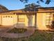 Charming single-story home with a white brick exterior, garage, and well-kept front lawn at 309 & 311 Sea Hawk Ct, Edgewater, FL 32141