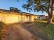Single story home with brick exterior, garage, mature landscaping and walkway at 309 & 311 Sea Hawk Ct, Edgewater, FL 32141