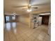 Open-concept living room with tile floors, adjacent kitchen, and ceiling fan at 309 & 311 Sea Hawk Ct, Edgewater, FL 32141