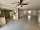 Open-concept living room connects kitchen and dining area with smooth access to front entryway at 309 & 311 Sea Hawk Ct, Edgewater, FL 32141