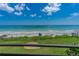 The condo's balcony boasts stunning views of ocean, beach, and lush green lawn at 3255 S Atlantic Ave # 201, Daytona Beach, FL 32118