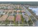 A birds eye view displays a well-maintained neighborhood with mature landscaping and tranquil lake views at 3456 Pegaso Ave, New Smyrna Beach, FL 32168