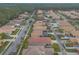 An aerial view showcases a community of single-Gathering homes, with manicured lawns on tree-lined streets at 3456 Pegaso Ave, New Smyrna Beach, FL 32168