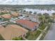 Aerial view of a home with a red tile roof in a residential neighborhood near a pond at 3456 Pegaso Ave, New Smyrna Beach, FL 32168