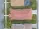 An aerial close-up of a house showing it's landscaping, roof, and driveway in a neighborhood at 3456 Pegaso Ave, New Smyrna Beach, FL 32168