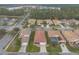 An aerial view shows beautiful single-Gathering homes in a well-planned community with mature trees and a tranquil lake at 3456 Pegaso Ave, New Smyrna Beach, FL 32168