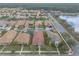 A birds eye view displays a well-maintained neighborhood with mature landscaping and tranquil lake views at 3456 Pegaso Ave, New Smyrna Beach, FL 32168