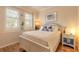 Inviting bedroom with large windows, plantation shutters, and a beach-themed decor at 3456 Pegaso Ave, New Smyrna Beach, FL 32168
