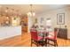 Bright dining area features wood floors, modern lighting, and sliding door access to the outside at 3456 Pegaso Ave, New Smyrna Beach, FL 32168