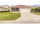Single-story home with a two-car garage, screened-in porch, and well-maintained lawn at 3456 Pegaso Ave, New Smyrna Beach, FL 32168