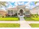 Charming home featuring a tiled roof, manicured lawn, and inviting front entrance at 3456 Pegaso Ave, New Smyrna Beach, FL 32168
