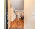 Welcoming hallway showcasing wood flooring and a view of the game room with a pool table at 3456 Pegaso Ave, New Smyrna Beach, FL 32168