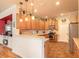 Well-lit kitchen featuring wooden cabinets, stainless steel appliances, and a cozy breakfast bar at 3456 Pegaso Ave, New Smyrna Beach, FL 32168
