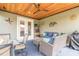 Screened in lanai provides extra space for seating and relaxation under a beautiful wood ceiling at 3456 Pegaso Ave, New Smyrna Beach, FL 32168