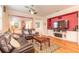 Comfortable living room with hardwood floors, ceiling fan, leather sofas, and cozy decor at 3456 Pegaso Ave, New Smyrna Beach, FL 32168