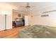 Lovely main bedroom featuring hardwood floors, a ceiling fan, and decorative wall art at 3456 Pegaso Ave, New Smyrna Beach, FL 32168