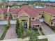 A beautiful aerial view of the townhomes, red roofs, and a fountain in the lake at Venetian Bay at 3546 Casalta Cir, New Smyrna Beach, FL 32168