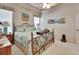 Serene bedroom featuring coastal artwork, a ceiling fan, and ample natural light from the windows at 3546 Casalta Cir, New Smyrna Beach, FL 32168