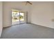 Bright bedroom featuring sliding glass doors that lead to a screened lanai at 3546 Casalta Cir, New Smyrna Beach, FL 32168