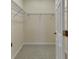 Walk-in closet featuring a metal shelf, neutral colored walls and carpet, and a door opening into the room at 3546 Casalta Cir, New Smyrna Beach, FL 32168