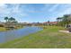 Beautiful community view showcasing a lake with fountain, lush landscaping, and charming residential homes at 3546 Casalta Cir, New Smyrna Beach, FL 32168