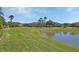 Picturesque community view featuring a tranquil lake surrounded by lush lawns and well-maintained homes at 3546 Casalta Cir, New Smyrna Beach, FL 32168