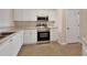 Modern kitchen featuring stainless steel appliances, tile flooring, and white cabinets at 3546 Casalta Cir, New Smyrna Beach, FL 32168