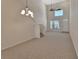 Open-concept space with carpet flooring, large windows, and bright, natural light at 3546 Casalta Cir, New Smyrna Beach, FL 32168