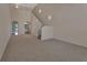 Unfurnished living room featuring high ceilings, carpet, and a staircase at 3546 Casalta Cir, New Smyrna Beach, FL 32168