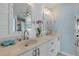 Bright bathroom with a double vanity, marble countertop, gold fixtures, and white cabinets offers a clean aesthetic at 3728 Egret Dunes Dr, Ormond Beach, FL 32176