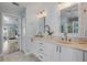 Stylish bathroom with a double vanity, marble countertop, gold fixtures, and plank wall design exudes elegance at 3728 Egret Dunes Dr, Ormond Beach, FL 32176