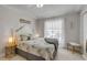 Bright bedroom with ceiling fan, window, and coastal-themed bedding, creating a relaxing atmosphere at 3728 Egret Dunes Dr, Ormond Beach, FL 32176