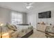 Well-lit bedroom featuring a ceiling fan, light-colored walls, and beachy-themed bedding at 3728 Egret Dunes Dr, Ormond Beach, FL 32176