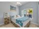 Cozy bedroom with a beachy theme, featuring natural light and a view of tropical foliage at 3728 Egret Dunes Dr, Ormond Beach, FL 32176