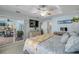 Bright bedroom with tile floor, ceiling fan, and patio access, complemented by beachy decor and natural light at 3728 Egret Dunes Dr, Ormond Beach, FL 32176