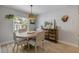 Charming dining area with round table, natural light, and views of the surrounding landscape at 3728 Egret Dunes Dr, Ormond Beach, FL 32176