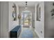 Inviting entryway featuring wood floors, a decorative rug, and recessed wall niches at 3728 Egret Dunes Dr, Ormond Beach, FL 32176