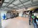 Well-organized garage featuring shelving, work area, and epoxy floor, providing functionality and ample space at 3728 Egret Dunes Dr, Ormond Beach, FL 32176
